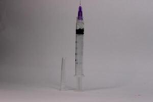 A syringe with a needle and a small tube photo