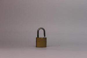A small padlock on a white surface photo