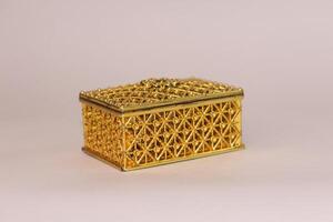 A gold box with intricate design on white background photo