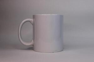 A white mug sitting on a table with a white background photo