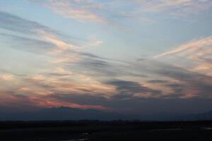 A kite flying in the sky at sunset photo