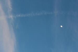 A plane flying in the sky with a contrail photo