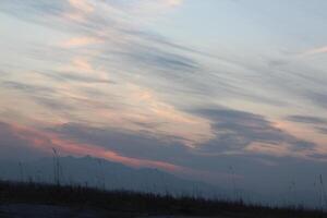 A person flying a kite in the sky photo