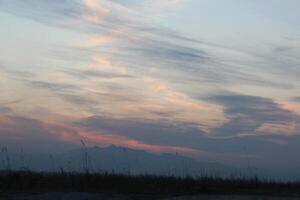 A kite flying in the sky at sunset photo
