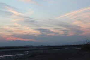 A person flying a kite in the sky photo