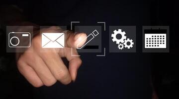 a person pressing a button with icons on it photo