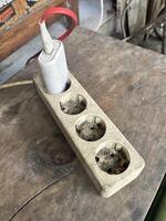 a wooden box with four sockets on top of it photo