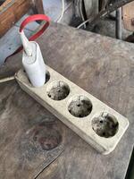 a wooden holder with four cups on it photo