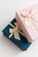 Two celebrated gift boxes lie on white background photo