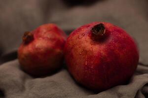 Pomegranate on canvas grey background photo