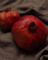 Pomegranate on canvas grey background photo