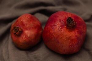 Pomegranate on canvas grey background photo