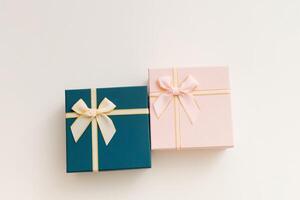 Two celebrated gift boxes lie on white background photo