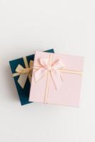 Two celebrated gift boxes lie on white background photo