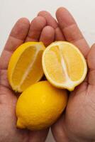 lemon in hands on white background photo