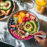 Colorful smoothie bowl topped with fresh fruits photo