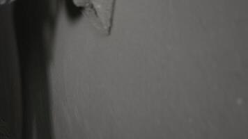 Worker smoothing plaster on a wall, Close-up of a worker using a plastering tool to smooth a wall surface. video