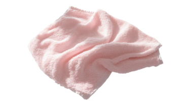 Soft pink towel draped casually on a flat surface, showcasing its plush texture and gentle color suitable for bathroom or spa use. png