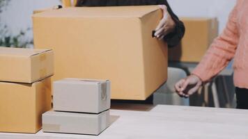 Two people are holding boxes and one is moving them video