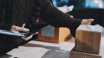 A person is holding a cell phone while standing next to boxes video