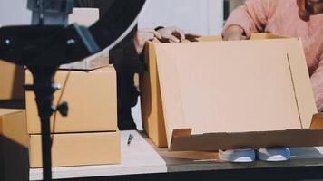 A woman is holding a box with a camera in front of it video