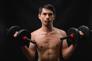 Strong Man Lifting Dumbbells for Physical Fitness and Health Goals photo