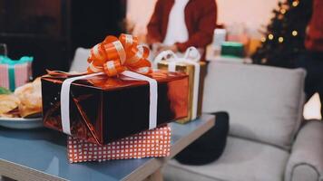 A man is standing in front of a table with presents video