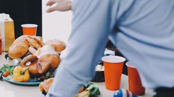 A man is standing over a table with food and drinks video
