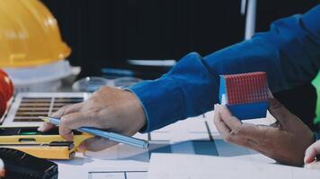 A man working on a construction project with a blue box video
