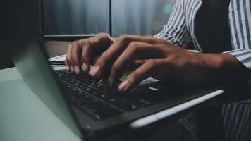 A person typing on a laptop computer video