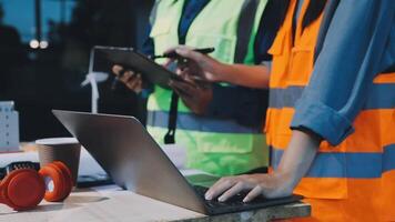 Two construction workers working on a laptop video