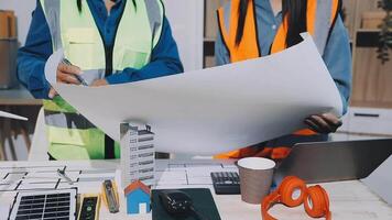 Two construction workers are working on a project video