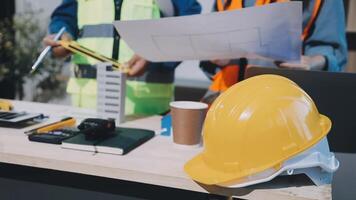 Two construction workers are working on a project video