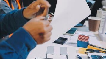 A man is holding a piece of paper while working on a project video
