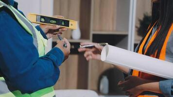 A man and woman in safety vests are holding a piece of paper video