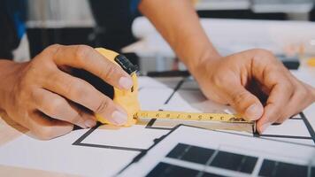 A person is measuring a piece of paper with a ruler video