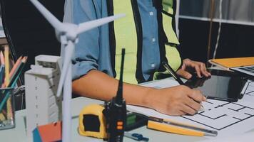 A man in a safety vest is working on a project video