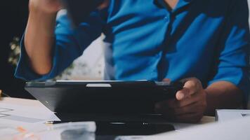 A person is holding a tablet computer in front of a desk video