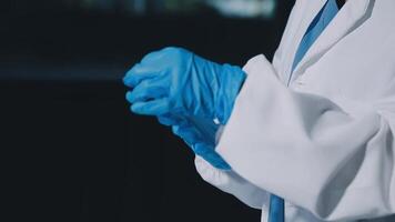 A person in a lab coat and blue gloves video