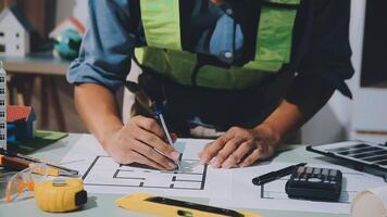 A man in a safety vest is working on a project video