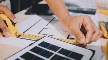 A person is using a ruler to measure a blueprint video