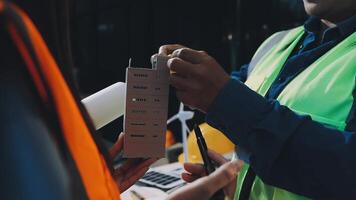 A man in a safety vest is holding a piece of paper video