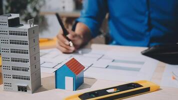 A man is working on a model of a house video