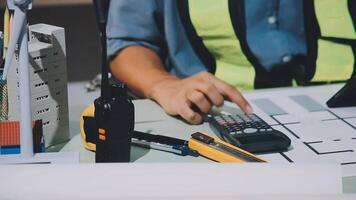 A person working on a project with a calculator and a pen video