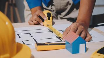 A person is using a ruler to measure a house video