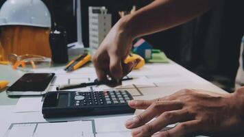 A person using a calculator on a table video