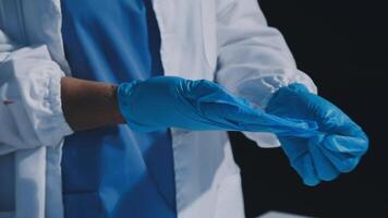 A person in a lab coat and blue gloves video