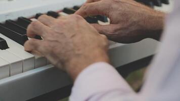 A close up of a man's hands playing the piano video