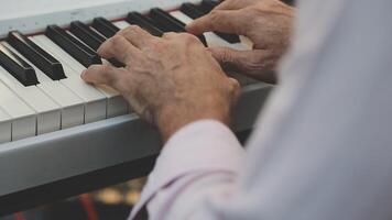 A close up of a man's hands playing the piano video