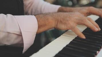 A close up of a man's hands playing the piano video
